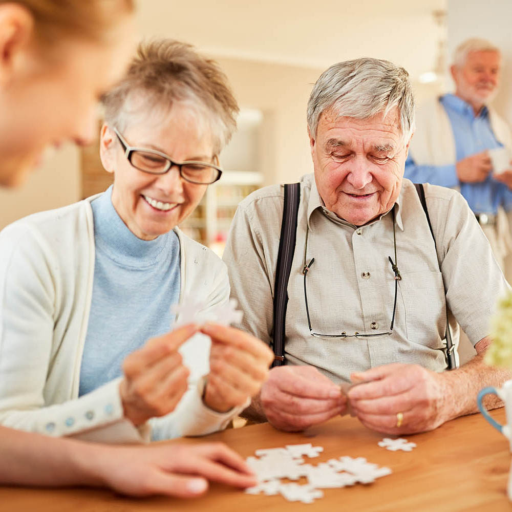 elderly playing a game and enjoying saving on their life insurance policy