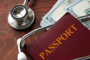 Medical,Tourism,Concept.,Stethoscope,With,Passport,And,Dollar,Bills.
